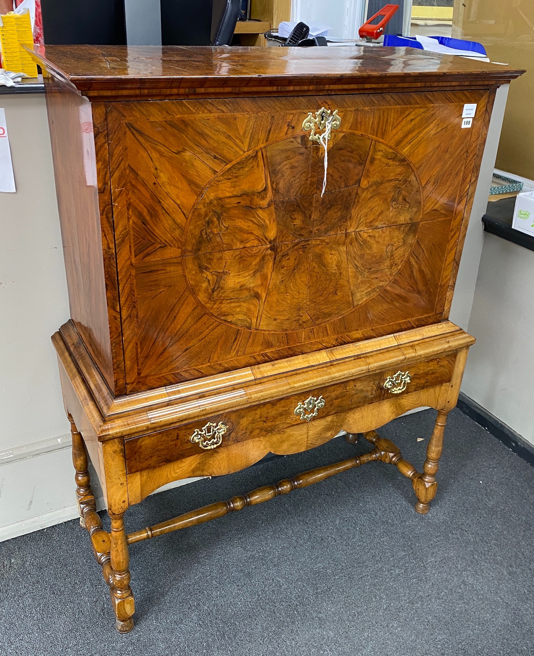 An early 18th century banded walnut fall front secretaire, the interior fitted with numerous drawers, raised on a later stand, width 110cm, depth 49cm, height 147cm